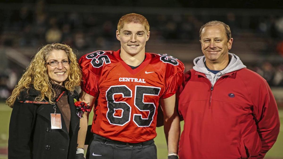 Timothy Piazza, center, with his parents Evelyn Piazza, left, and James Piazza, right, during Hunterdon Central Regional High School football's "Senior Night" at the high school's stadium in Flemington, N.J.