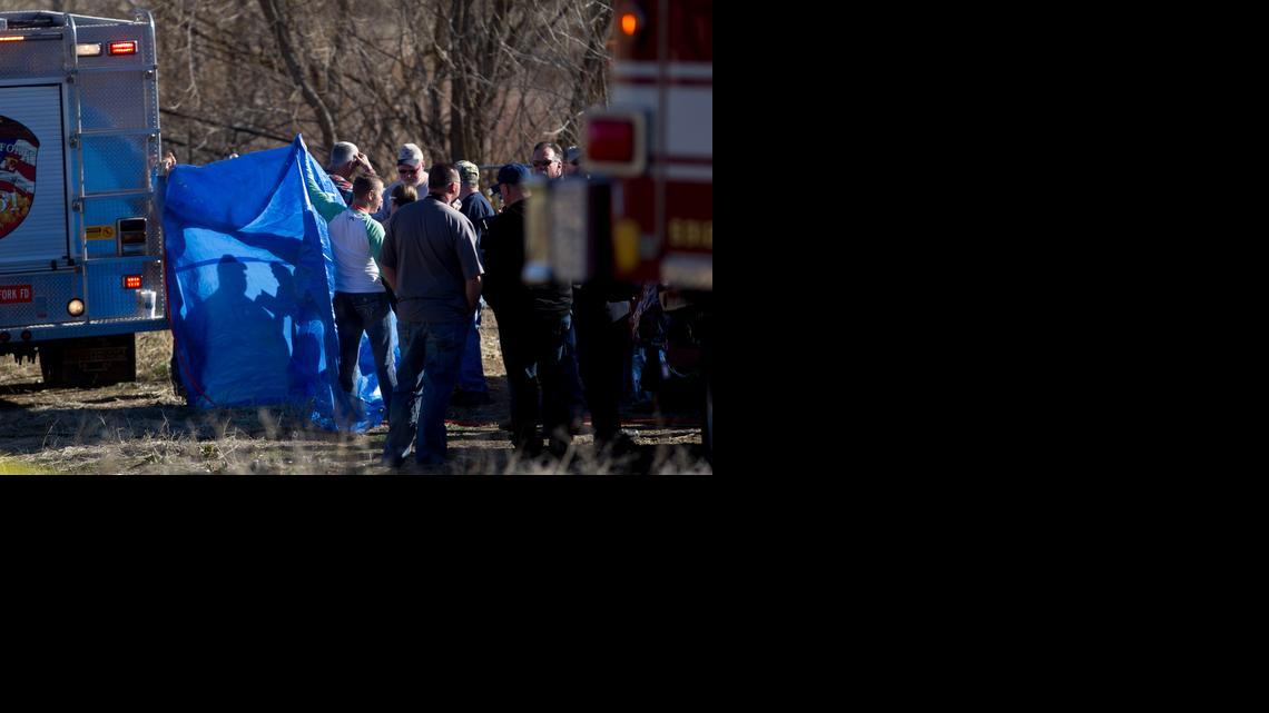 
In this March 7, 2015 photo, officials respond to a report of car in the Spanish Fork River near the Main Street and the Arrowhead Trail Road junction in Spanish Fork, Utah. An 18-month-old girl survived a car crash in a frigid Utah river after being strapped in a car seat upside-down for some 14 hours before being found by a fisherman, but her 25-year-old mother, Lynn Groesbeck, of Springville, was found dead in the car, police said Sunday. 
