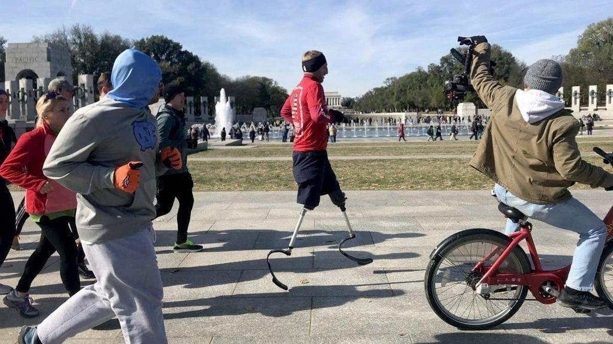 Rob Jones runs by the World War II Memorial in Washington, D.C.