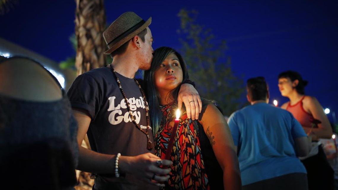 Two people embrace during a vigil at The Center, a community center for the LGBT community, Sunday, June 12, 2016, in Las Vegas. The vigil was for the victims of the Pulse nightclub shooting in Orlando.