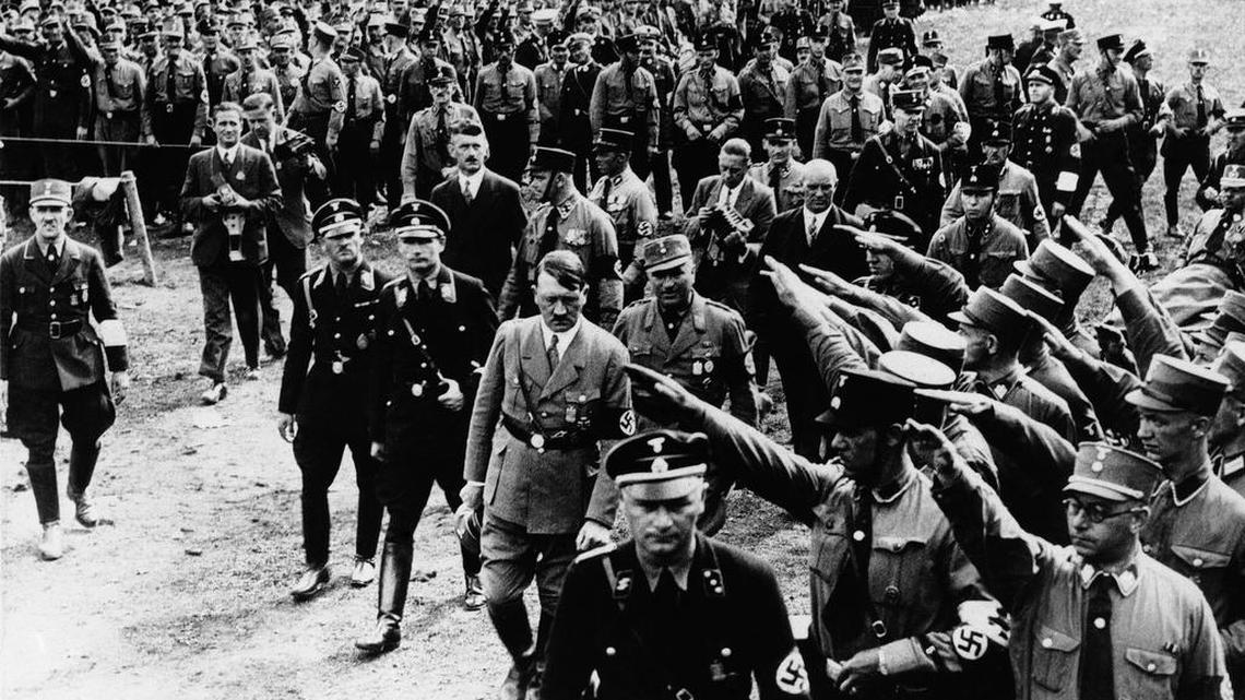 Adolf Hitler, with an honor guard saluting, on the great demonstration field at Nuremberg, when nearly a million Germans gathered to show their faith in the Hitler regime, Sept. 13, 1933.