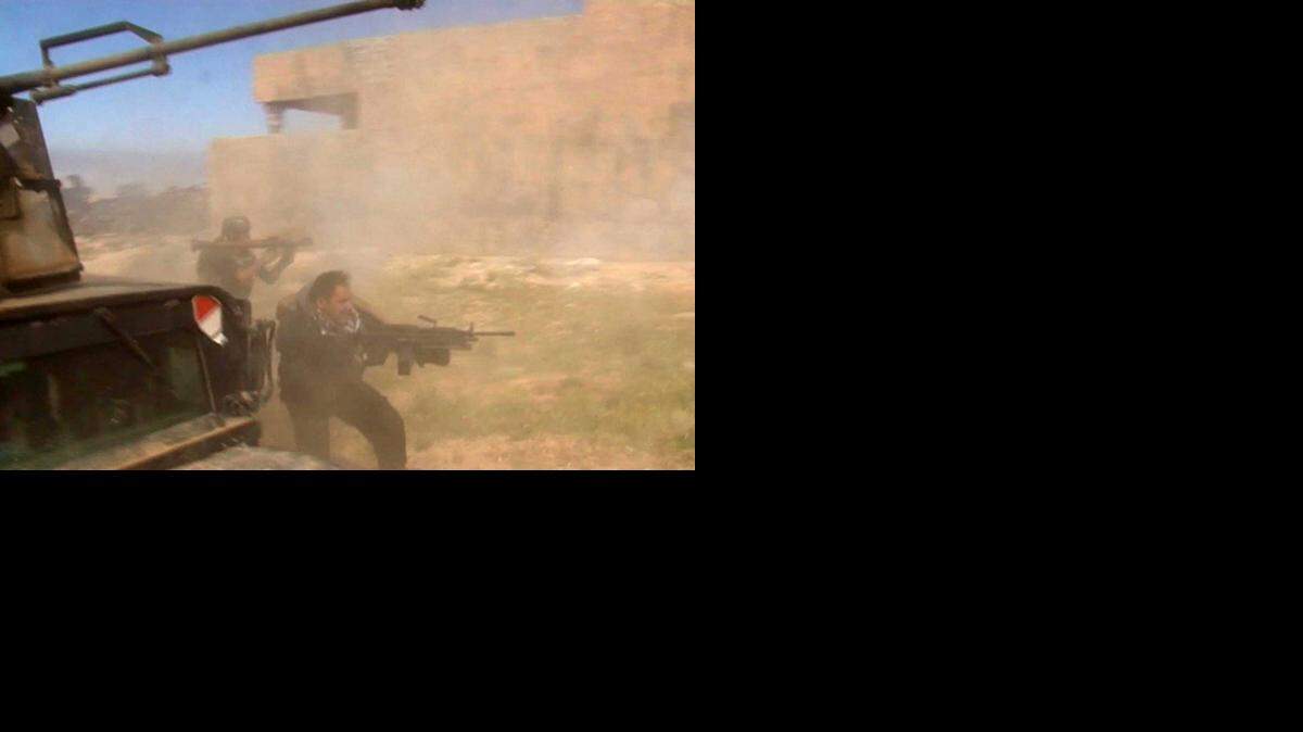 
In this still image taken from video, soldiers fire toward a target in Tikrit, Iraq on Wednesday, March 11, 2015. Only 1,000 Sunni tribesmen are taking part in the battle to recapture Tikrit, while 20,000 members of Shiite militias have converged on the city, the hometown of the late Iraqi leader Saddam Hussein, Army Gen. Martin Dempsey, chairman of the Joint Chiefs of Staff, told the Senate Foreign Relations Committee.
