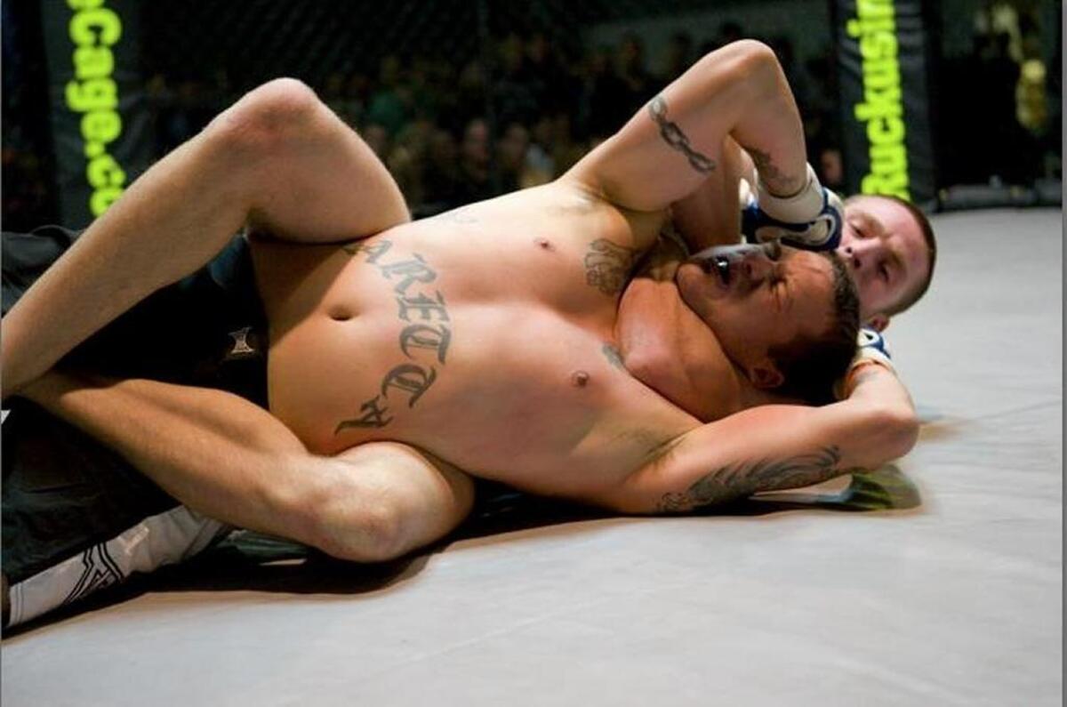Jordan Rinaldi chokes Dennis Paretta into submission during his first amateur fight, part of the “Ruckus in the Cage” at Metrolina Tradeshow Expo on Nov. 14, 2008.
