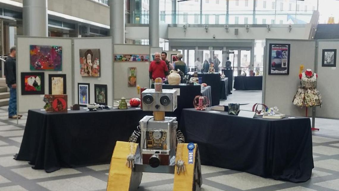 Viewers mill about the annual Denver Public Schools system's best-of-city art show on display in the lobby of the Wellington Webb Office building in downtown Denver March 25, 2016. One piece of art in the display triggered a storm of controversy from the Denver police unions which ended when the painting was withdrawn from the exhibit by the artist, who is in 10th grade.