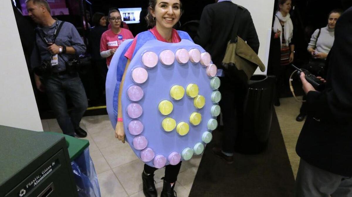 Valerie Marchesi, of Merrick, N.Y., dresses in a costume representing oral contraceptive pills before the start of an event Sunday, Jan. 10, 2016, in Hooksett, N.H., during which Democratic presidential candidate Hillary Clinton was endorsed by Planned Parenthood.