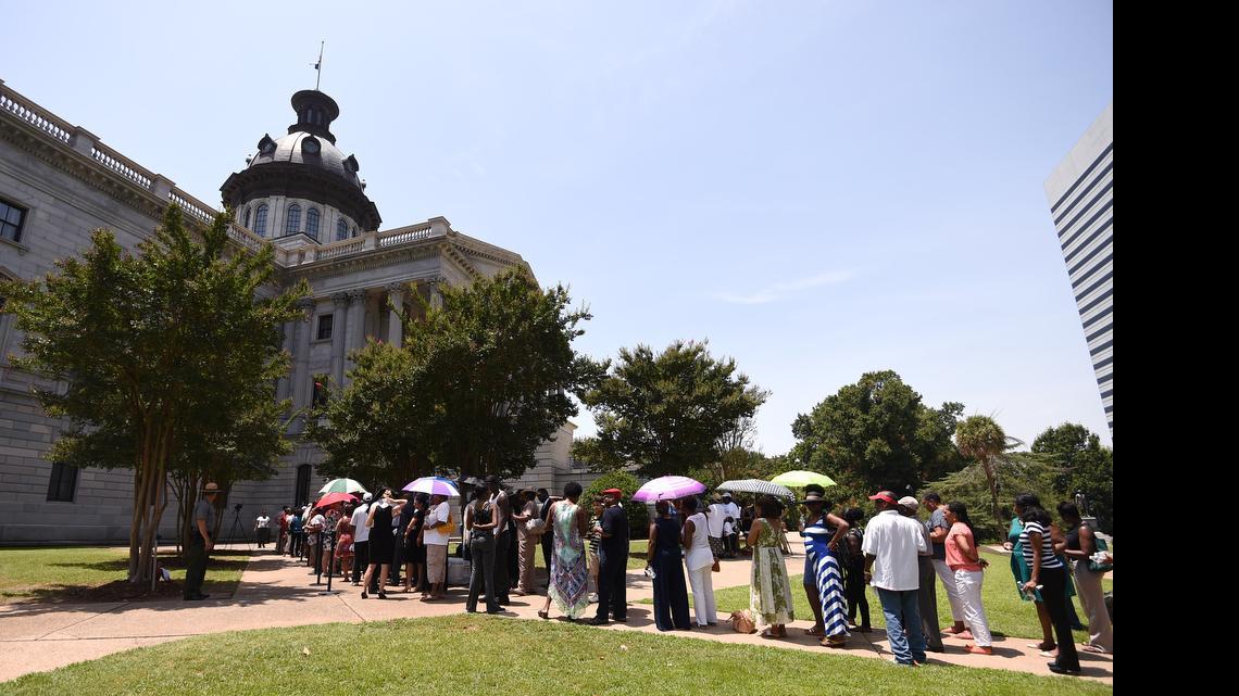 
People wait in line to enter the South Carolina Statehouse before a public viewing of Sen. Clementa Pinckney on Wednesday, June 24, 2015, in Columbia, S.C. President Barack Obama is scheduled to deliver the eulogy at Pinckney's funeral Friday morning at the College of Charleston. 
