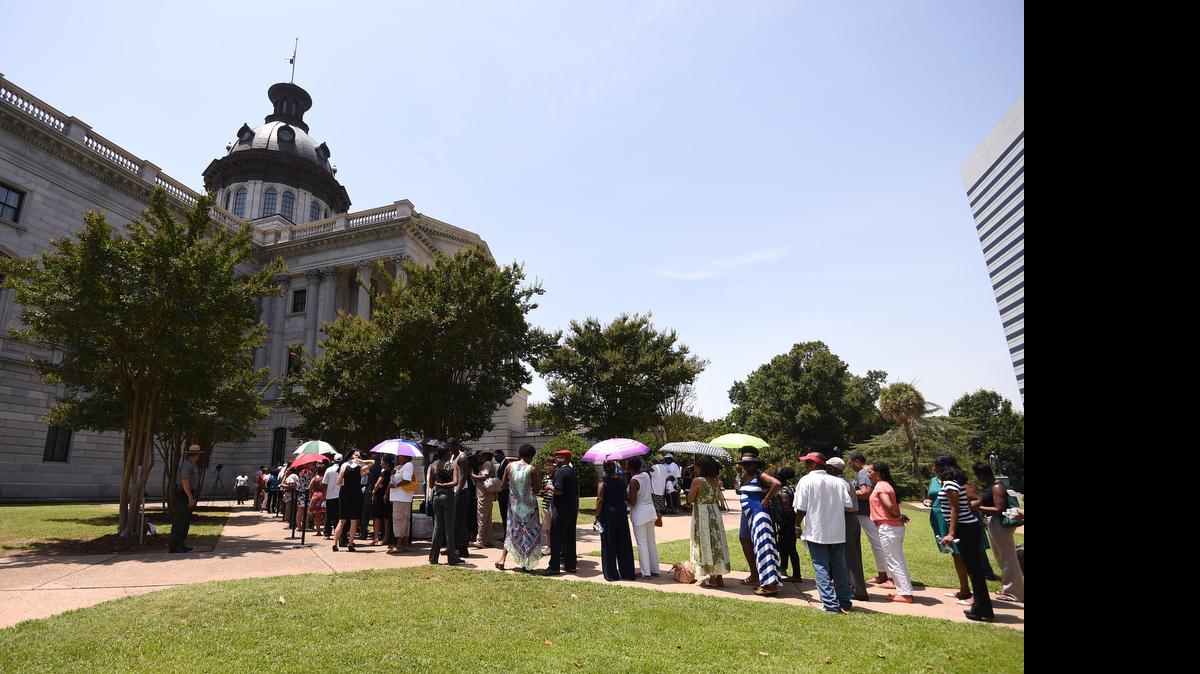 
People wait in line to enter the South Carolina Statehouse before a public viewing of Sen. Clementa Pinckney on Wednesday, June 24, 2015, in Columbia, S.C. President Barack Obama is scheduled to deliver the eulogy at Pinckney's funeral Friday morning at the College of Charleston. 
