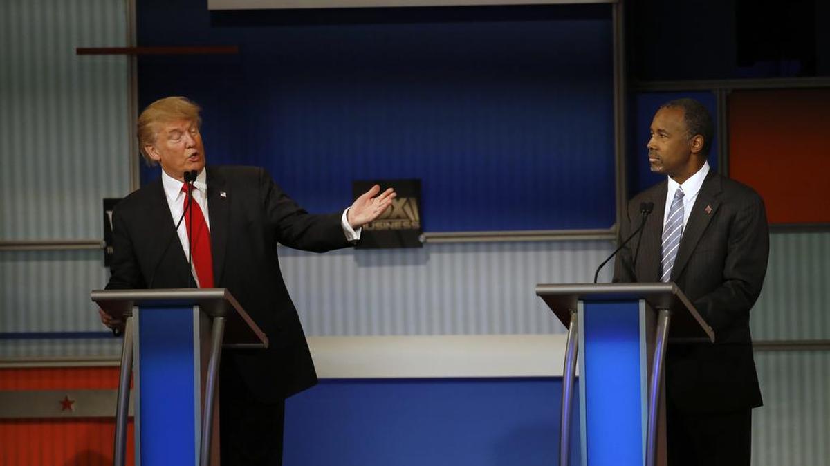 Donald Trump speaks as Ben Carson listens during the Republican presidential debate at the Milwaukee Theatre, Wednesday, Nov. 11, 2015, in Milwaukee. Both candidates have criticized the handling of protests at the University of Missouri and Yale University while Democratic candidates Bernie Sanders and Hillary Clinton expressed support for students.