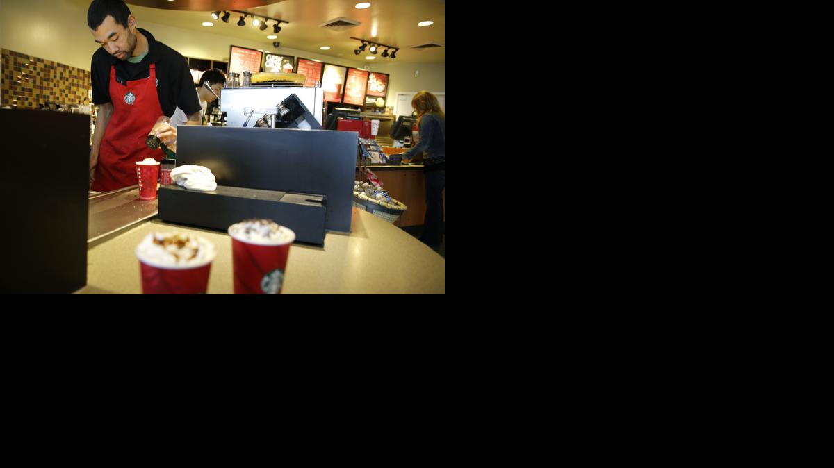 
Barista Jay Rapp prepares a Chestnut Praline Latte at a Starbucks store in Seattle on Nov. 24, 2014. 
