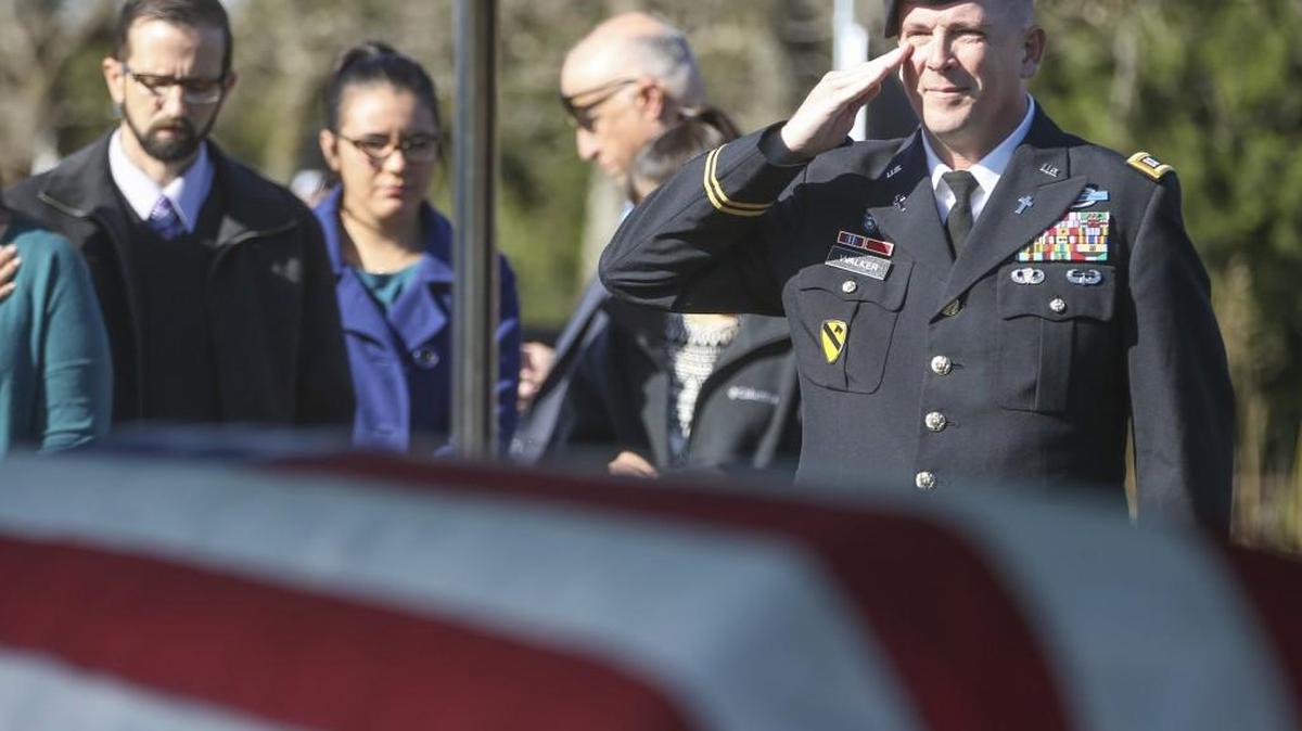 Capt. Paul Walker salutes the casket containing the remains of Cpl. Wayne Minard on Saturday. Minard died in a North Korean POW camp in 1951 and his remains were recently identified using DNA testing.