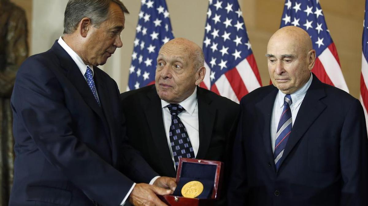 House Speaker John Boehner of Ohio, left, presents the Congressional Gold Medal to Monuments Men Harry Ettlinger, center, and Richard Barancik, Thursday, Oct. 22, 2015, during a ceremony in Emancipation Hall on Capitol Hill in Washington. The award is Congress' highest honor of appreciation for distinguished achievement.