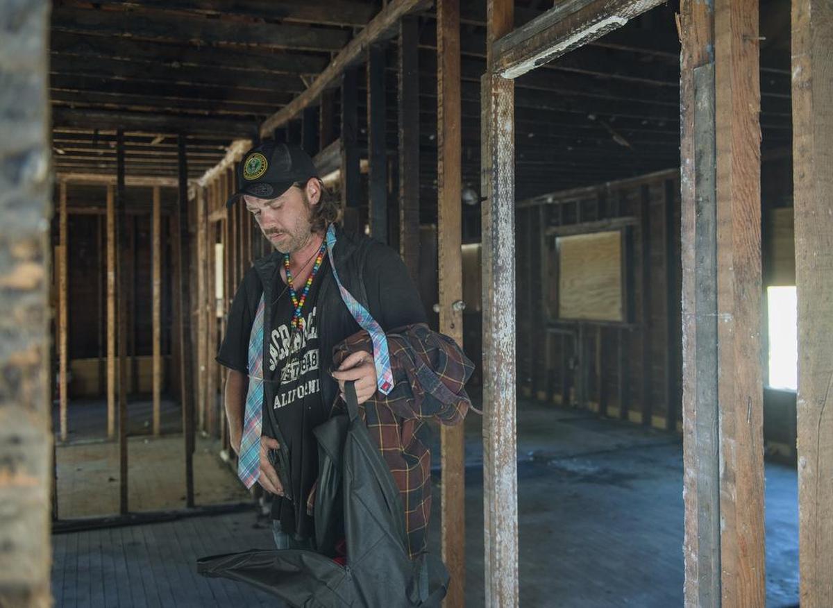 Thomas Mullen gathers his belongings as he leaves the abandoned home he has been staying in on Truckee Way off 34th Street to pick up his "pod" home from Caltrans on Thursday July 20, 2017, in Sacramento, Calif. Mullen has been staying there since July 12, when Caltrans impounded his pod home. Thomas' father, Jim, built the pod for his son.