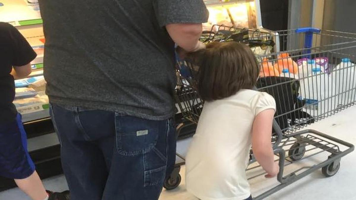 Erika Burch posted a photo on Facebook of a man pulling his daughter by her hair through a Walmart. When Burch confronted the man, she said he told her to mind her own business.