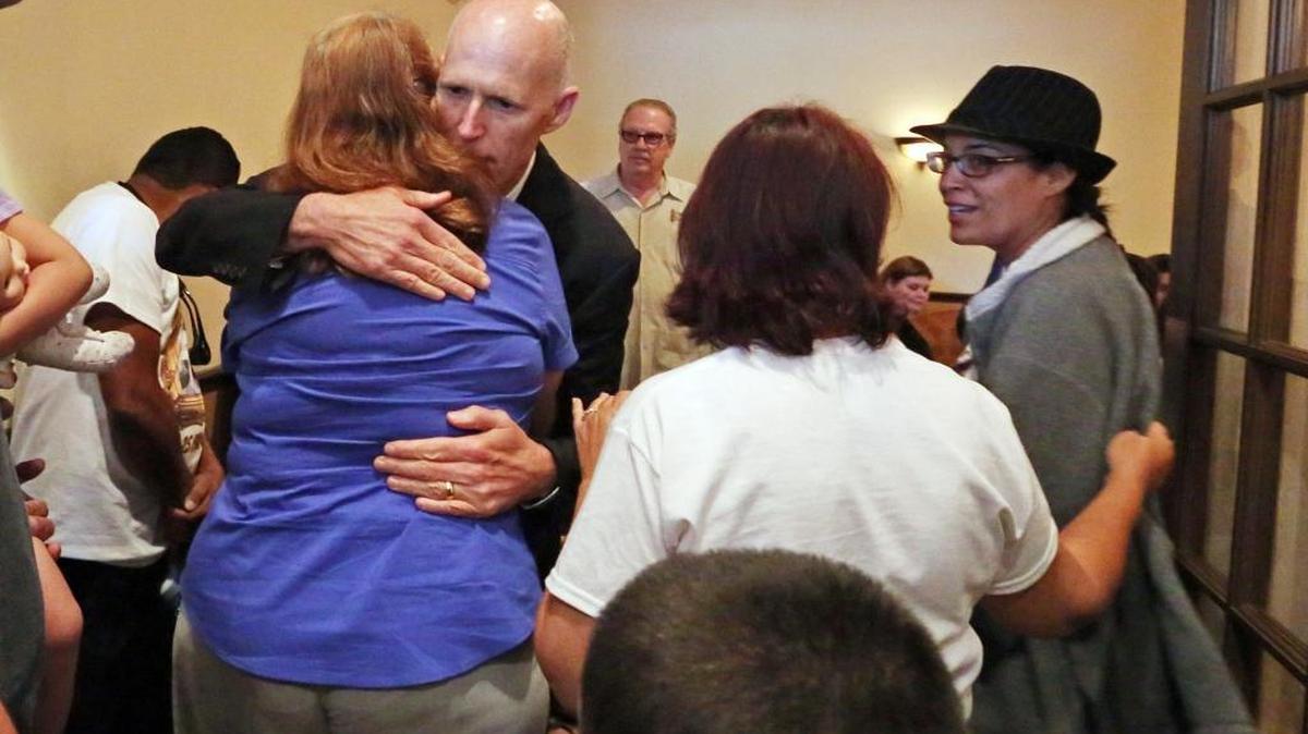 Gov. Rick Scott hugs Maria Delos Angeles, during a wake for her son, Eric Ivan Ortiz-Rivera, Thursday, June 16, 2016, at San Juan Funeraria in Kissimmee.