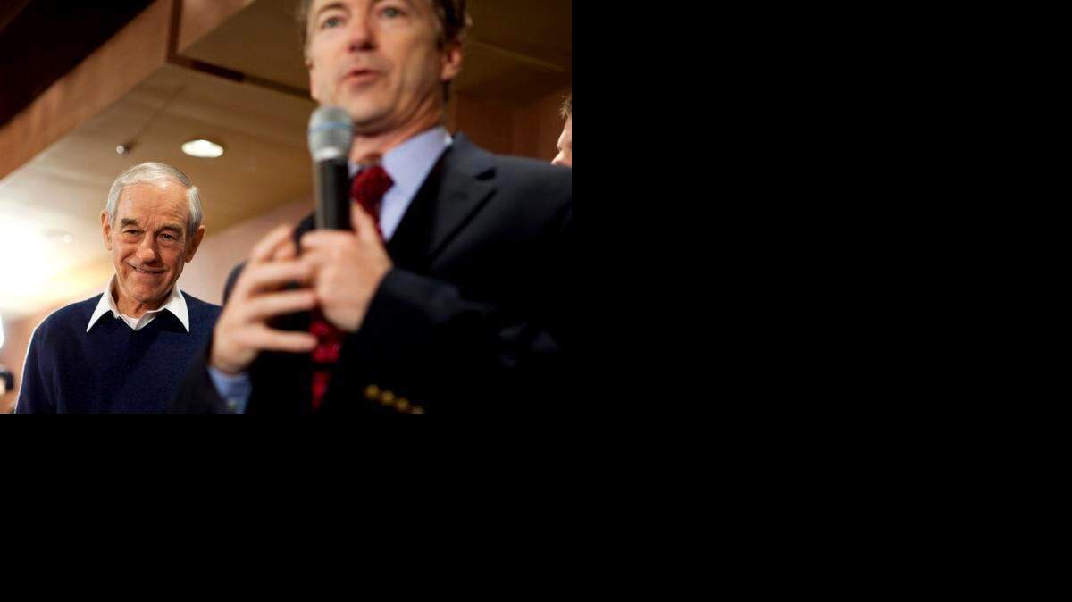 
Ron Paul, former candidate for the Republican presidential nomination, with his son, Rand Paul, at a town hall in Meredith, N.H., Jan. 8, 2012. When Sen. Rand Paul (R-Ky.) is expected to announce his candidacy for the 2016 Republican nomination on April 7, 2015, his father, Ron, will have a silent role. 
