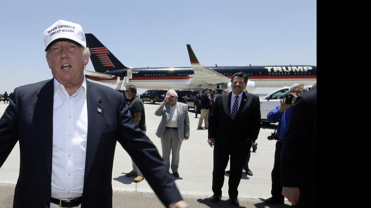 
Republican presidential hopeful Donald Trump speaks after arriving at the airport for a visit to the U.S. Mexico border in Laredo, Texas, Thursday, July 23, 2015. Trump is touring the border area to highlight his concerns about immigration policies. 
