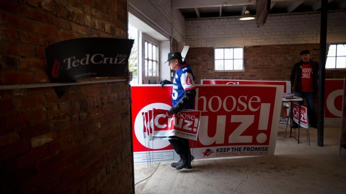 Is Ted Cruz the heir to the legacy of Ronald Reagan and Barry Goldwater? Lloyd Hedrick carries a large sign for Cruz after attending a campaign event in Osceola, Iowa.