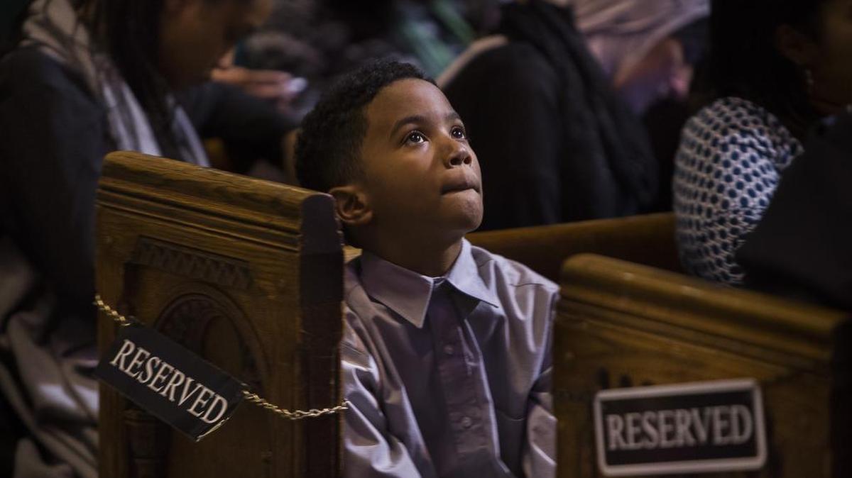 A child listens to a speech during an event celebrating the life and legacy of the Rev. Martin Luther King Jr. at the Riverside Church in New York on Monday, Jan. 18, 2016. The event, organizers said, was meant not only to celebrate King’s legacy but also to provide a discussion on how to continue his message of racial harmony in today’s climate.
