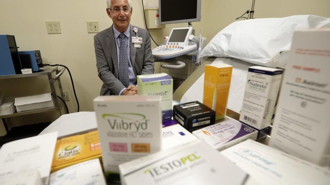 Dr. Irwin Goldstein poses in his office in San Diego behind a display of medicines for impotence and other sexual problems. For couples who can’t afford the soaring prices for the prescriptions, some take a big risk, buying “herbal Viagra” at gas stations or ordering Viagra online from “Canadian pharmacies” that likely sell counterfeit drugs made in poor countries, says Goldstein, director of San Diego Sexual Medicine.