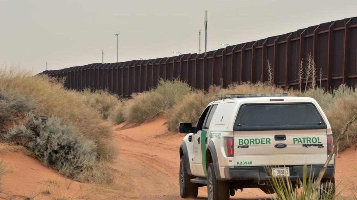 A U.S. Border Patrol agent drives near the U.S.-Mexico border fence in Santa Teresa, N.M. in this Jan. 4, 2016 photo. An increase in families and children arriving at the U.S. southern border from Central America has prompted fears of another crisis like the one that dominated national news during the summer of 2014. (AP Photo/Russell Contreras)