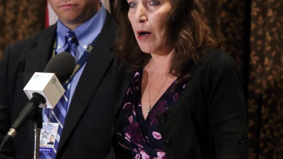 Fox Lake Village Manager Anne Marrin accompanied by Lake County sheriff’s Detective Chris Covelli speaks during a news conference Wednesday, Nov. 4, 2015, in Round Lake Beach, Ill., confirming that Fox Lake police Lt. Charles Joseph Gliniewicz died of a self-inflicted gunshot wound. Gliniewicz mentioned Marrin in several text messages released today.
