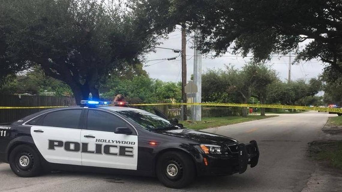 Crime scene tape and a Hollywood, Fla. police vehicle block off North 64th Avenue near Grant Street as police investigate a shots fired call.