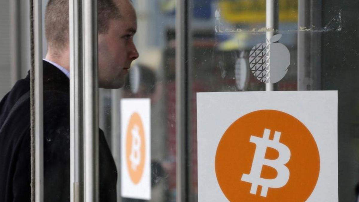 A man enters the Inside Bitcoins conference and trade show in New York in 2014. The bitcoin network is consuming more energy, and takes a heavy toll on power grids.