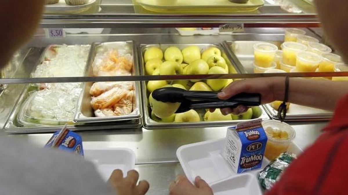 A student goes through a middle school lunch line.