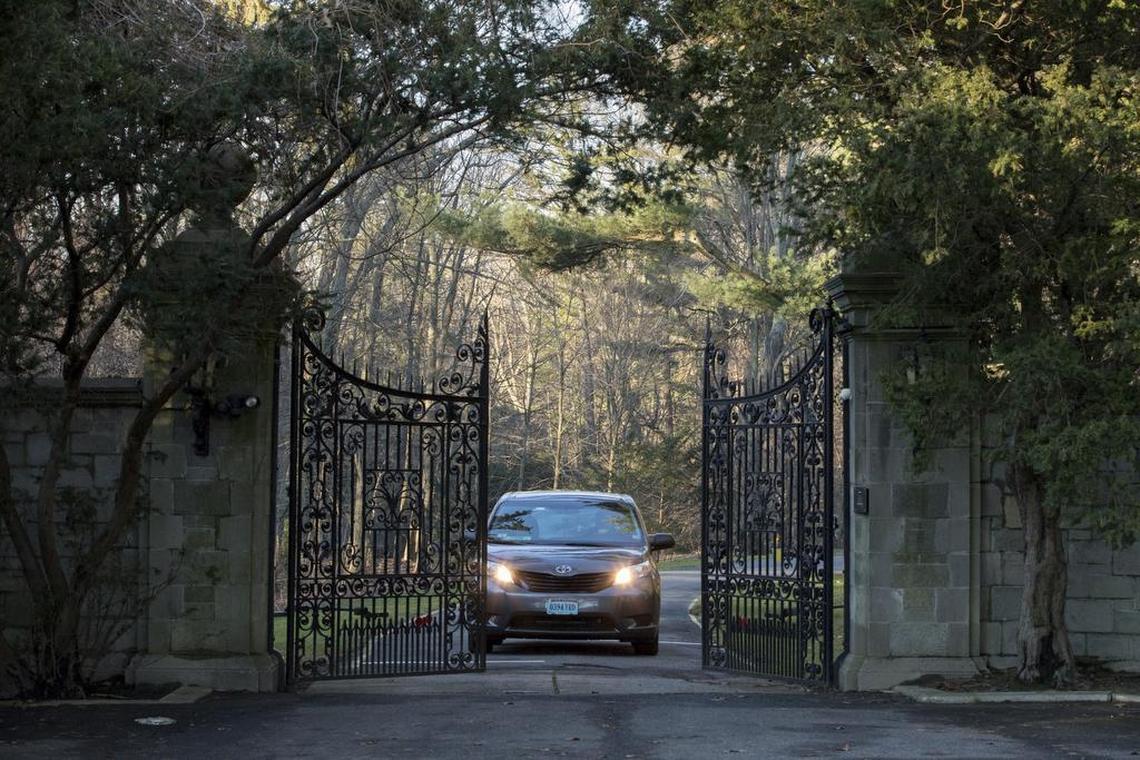A car with diplomatic license plates drives out of a compound near Glen Cove, N.Y., on Long Island on Friday, Dec. 30, 2016. Russia maintains this and another weekend retreat for its United Nations diplomats about an hour's drive outside New York City — each in one of Long Island's old Gold Coast mansions. U.S. officials didn't clarify which of the two countryside compounds would be closed.