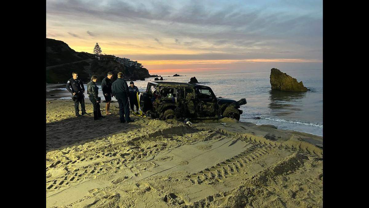 A Jeep was pulled out of the water at Corona Del Mar Beach by California officials.