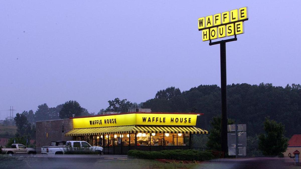 Traffic flashes by breakfast diners a a Waffle House near Dawsonville, Ga., Thursday, July 28, 2005. Employees of a Waffle House in Celina, Ohio, received a $3,500 tip.