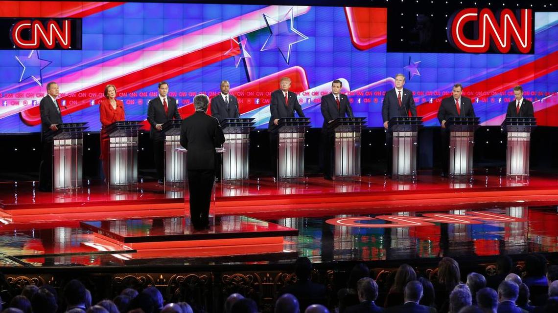 Republican presidential candidates, from left, John Kasich, Carly Fiorina, Marco Rubio, Ben Carson, Donald Trump, Ted Cruz, Jeb Bush, Chris Christie, and Rand Paul share the stage with debate moderator Wolf Blitzer during the CNN Republican presidential debate at the Venetian Hotel & Casino on Tuesday, Dec. 15, 2015, in Las Vegas.