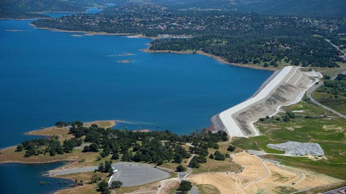 FILE - An aerial view of the newly-strengthened Morman Dam, right, which holds back water at Folsom Lake on Monday, May 1, 2017 in Folsom, Calif.