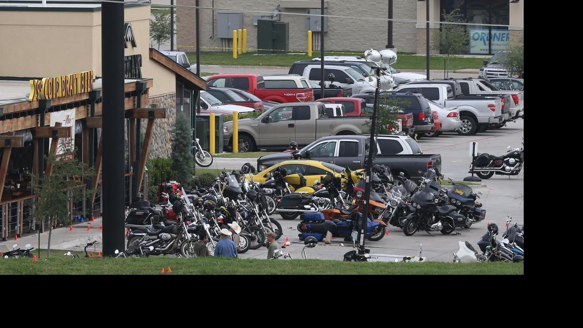 
Law enforcement continue to investigate the motorcycle gang related shooting at the Twin Peaks restaurant, Monday, May 18, 2015, in Waco, Texas, where 9 were killed Sunday and over a dozen injured. Waco police on Monday announced the Texas Alcoholic Beverage Commission closed Twin Peaks for a week amid safety concerns. 
