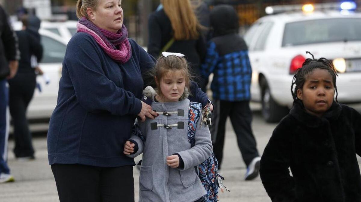 Students at Amy Beverland Elementary School are picked up after school after a bus accident in Indianapolis on . 26, 2016. Authorities said the principal was killed and two children were seriously injured.