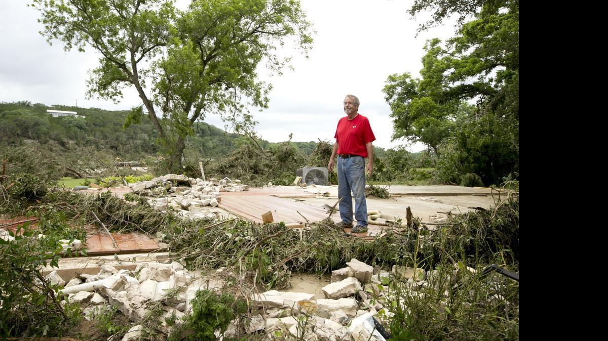 
Mike Graf stands on the foundation of his home near Wimberley on Stone Canyon Street after it was completely swept away by the Blanco River in the flood on Sunday May 24, 2015. "It's only things," he said. "At least nobody was hurt." 
