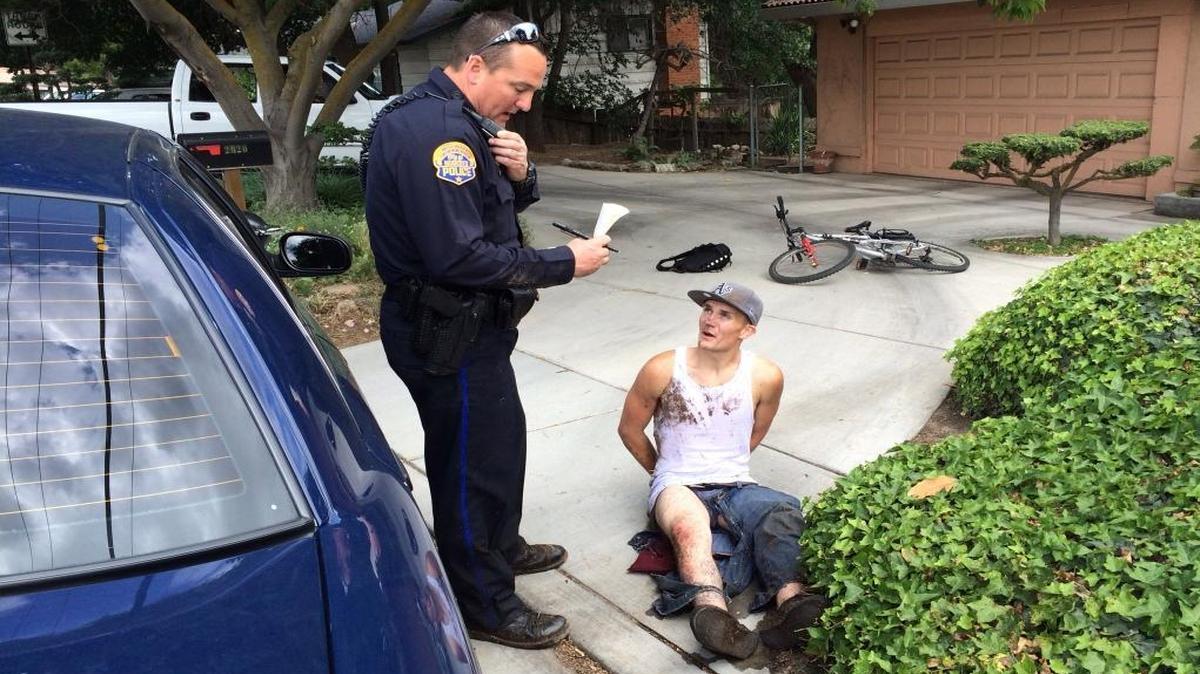 Modesto Police officer Mike Pershall is pictured with suspect David Luque on May 5, 2014. A resident called 911 to report he was following a male who was in his neighbor’s backyard and was now riding a bicycle out of the area. The resident followed the suspect to the 2000 block of Scenic Drive where he was seen going into the back yard of another residence. Pershall quickly arrived in the area and saw Luque standing on the front porch. Luque started to go along with Pershall’s commands, but then got up and ran toward the river. The officer and the resident chased Luque through the river and were able to apprehend him near the Dry Creek Trail.