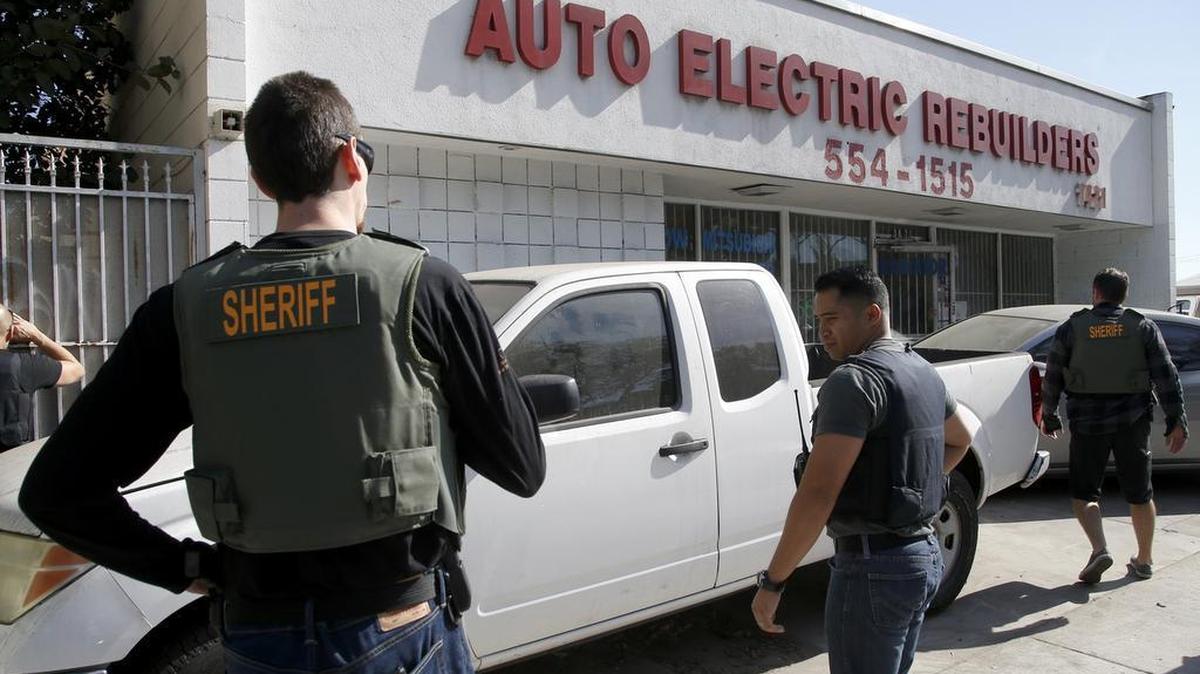 Law enforcement teams converge on the Auto Electric Rebuilders shop on Harbor Boulevard in Santa Ana, Calif., after jail escapee Bac Duong had been taken away after surrendering on Friday, Jan. 29, 2016.