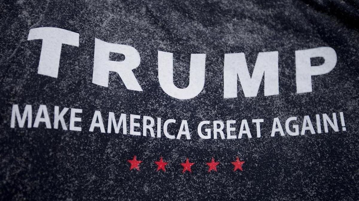 Snow collects on a pile of T-shirts for sale outside a campaign event for Republican presidential candidate Donald Trump at the Londonderry Lions Club Monday, Feb. 8, 2016, in Londonderry, N.H.