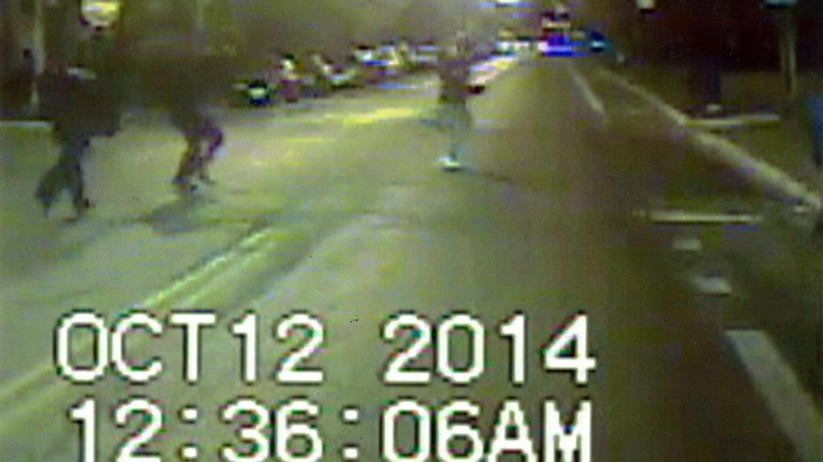 In this frame grab image made from an Oct. 12, 2014, video released by Chicago Police Department, Ronald Johnson, right, is seen running from police officers just before he was shot by an officer. Prosecutors say a Chicago police officer will not be charged in the shooting of the 25-year-old black man, who authorities said pointed a gun in the direction of officers.