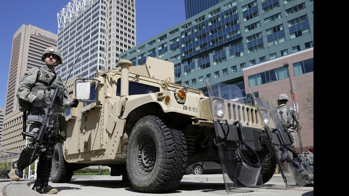 
Maryland National Guardsmen patrol near downtown businesses in Baltimore, Tuesday, April 28, 2015, a day after looting and arson erupted following the funeral of Freddie Gray. Gray died from spinal injuries about a week after he was arrested and transported in a Baltimore Police Department van.
