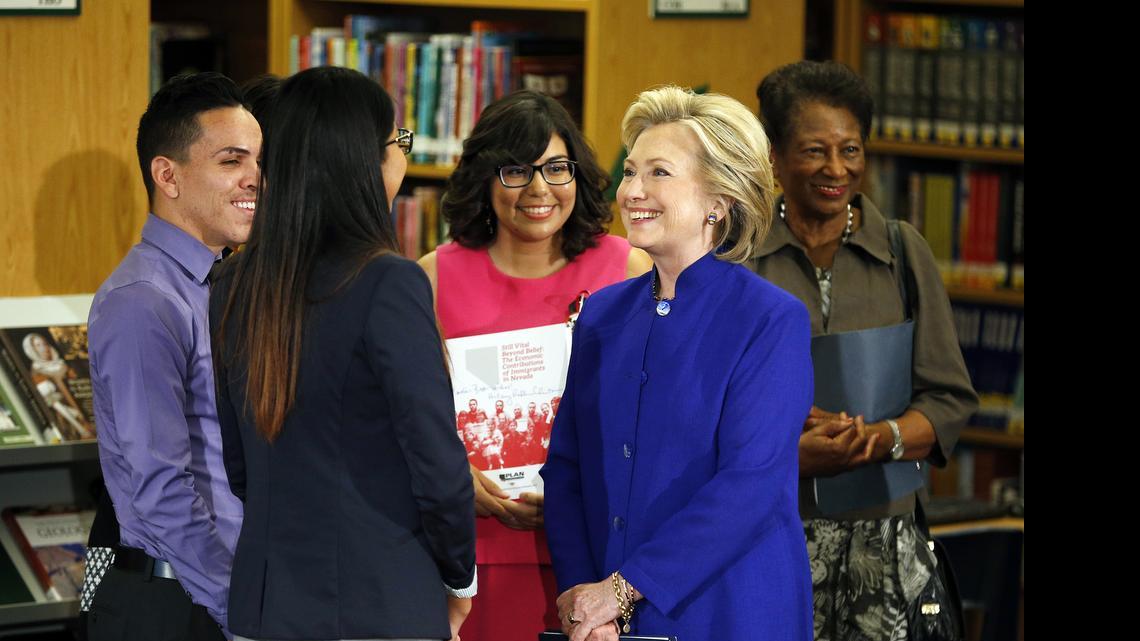
Hillary Rodham Clinton, a 2016 Democratic presidential contender, second from right, speaks with a group, including students, about immigration at an event at Rancho High School May 5, 2015, in Las Vegas. 
