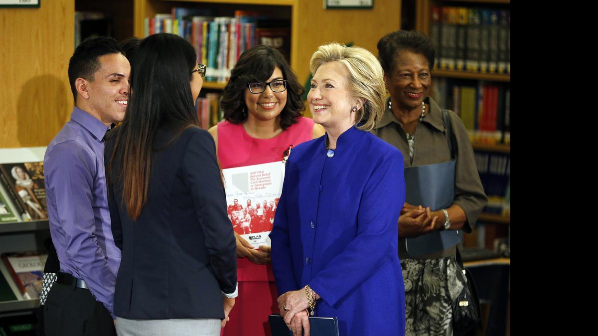 
Hillary Rodham Clinton, a 2016 Democratic presidential contender, second from right, speaks with a group, including students, about immigration at an event at Rancho High School May 5, 2015, in Las Vegas. 
