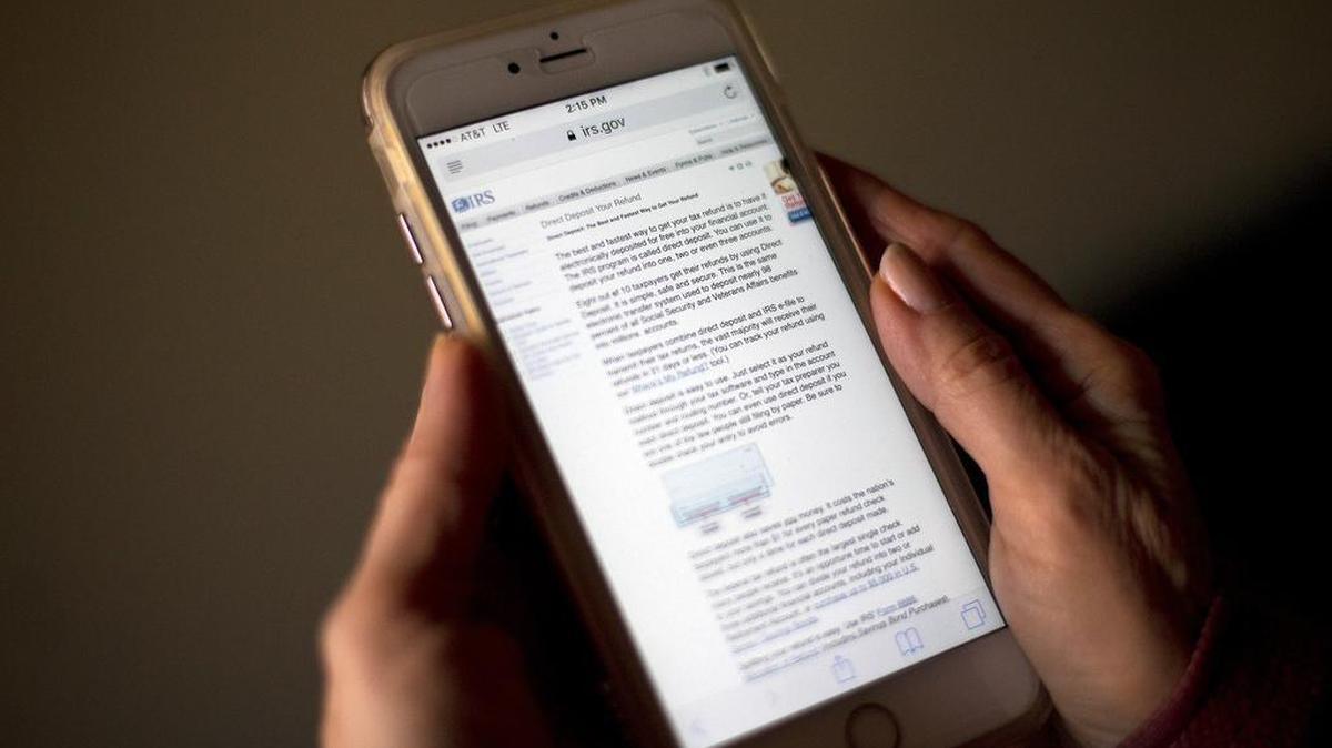 A page from IRS.gov regarding IRS electronic filing information for a direct deposit of a refund is displayed on a mobile phone screen. The IRS stopped accepting electronically filed tax returns Wednesday because of problems with some of its computer systems. The outage could affect refunds, but the agency said it doesn’t anticipate “major disruptions.”