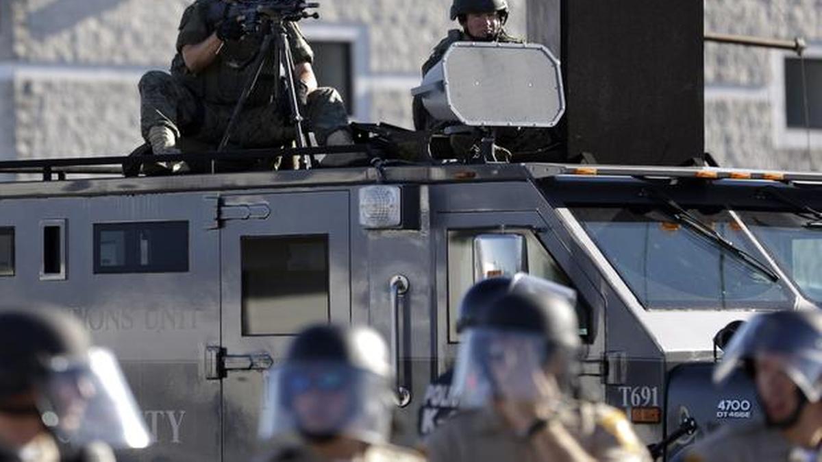 
In this Aug. 9, 2014, file photo, a police tactical team moves in to disperse a group of protesters in Ferguson, Mo., that was sparked after Michael Brown, an unarmed black 18-year-old, was shot and killed by white police officer Darren Wilson. The Justice Department announced Wednesday, March 4, 2015, that Wilson will not be charged.
