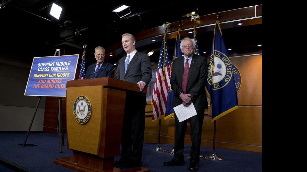 
Rep. Chris Van Hollen, D-Md.,, center, flanked by Sen. Bernie Sanders, I-Vt., right, and Sen. Charles Schumer, D-N.Y., speaks during a news conference on Capitol Hill in Washington on Wednesday against the Republican backed budget that they say will hurt American middle class families.
