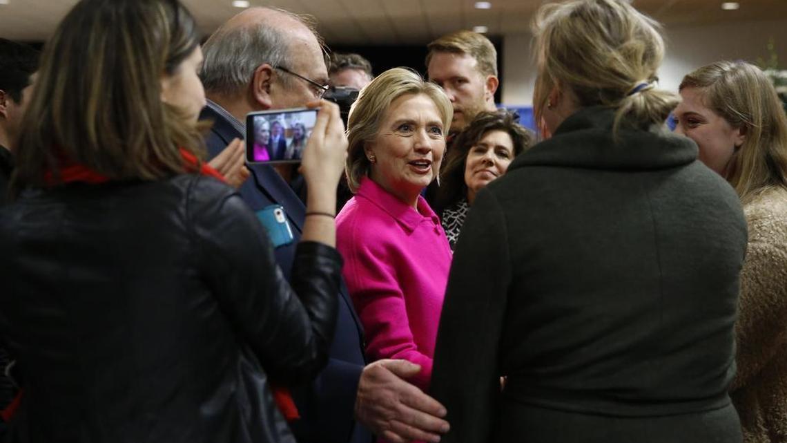 Democratic presidential candidate Hillary Clinton visits with attendees before speaking at the Scott County Democrats Red, White and Blue Banquet in Davenport, Iowa, Saturday, Jan. 23, 2016.