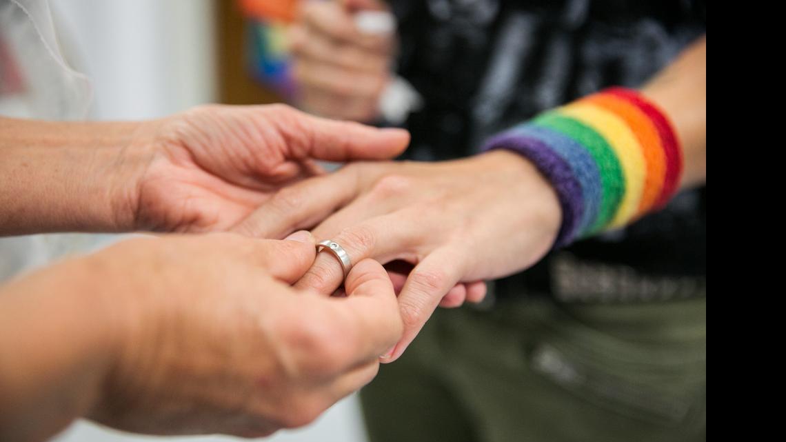 
Natalie Novoa has her wedding ring put on by Eddie Daniels, left, as the couple marry during a ceremony at the L.A. County Registrar office in Beverly Hills, Calif., on Friday, June 26, 2015. The couple have been together for the past 11 years and have been waiting to wed this auspicious day in which the U.S. Supreme Court ruled that same-sex couples have a constitutional right to marriage.
