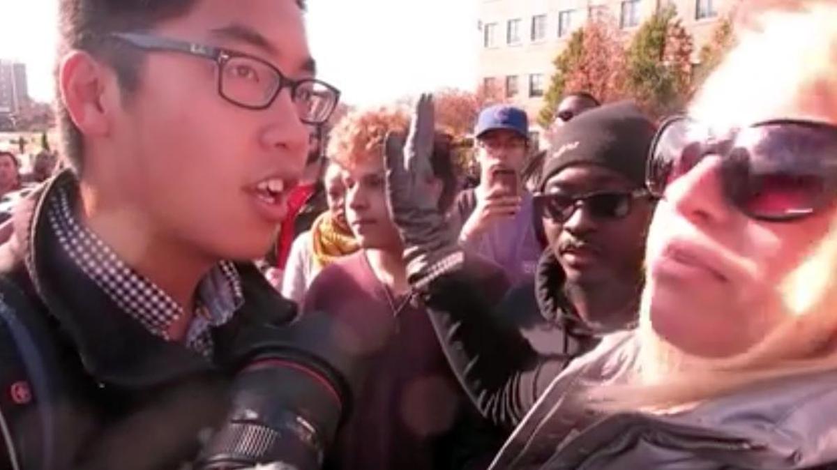 In this Nov. 9, 2015 frame from video, Janna Basler, right, who works in the University of Missouri's office of Greek life, tells photographer Tim Tai, to "leave these students alone" in their "personal space," in Columbia, Mo. Bradley Campbell, an associate professor at Cal State Los Angeles, says the microagression movement is transforming society from a “dignity culture” to a “victimhood culture.” He cites this incident as an example of conflicts that could result.