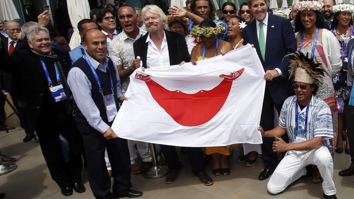 
Virgin Group Founder Richard Branson, center left, holds the Easter Island flag with U.S. Secretary of State John Kerry on the sidelines of the Our Ocean international conference on marine protection in Vina del Mar, Chile, Monday, Oct. 5, 2015. President Barack Obama declared new marine sanctuaries in Lake Michigan and the tidal waters of Maryland on Monday, while Chile blocked off a vast expanse of the Pacific Ocean near the world-famous Easter Island from commercial fishing and oil and gas exploration.
